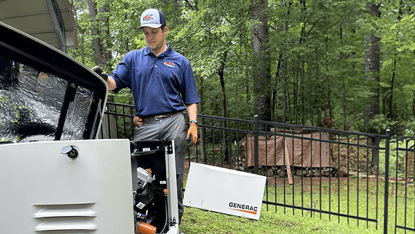 Evans Air technician performing generator installation and maintenance on a residential Generac unit in Tyler, TX.