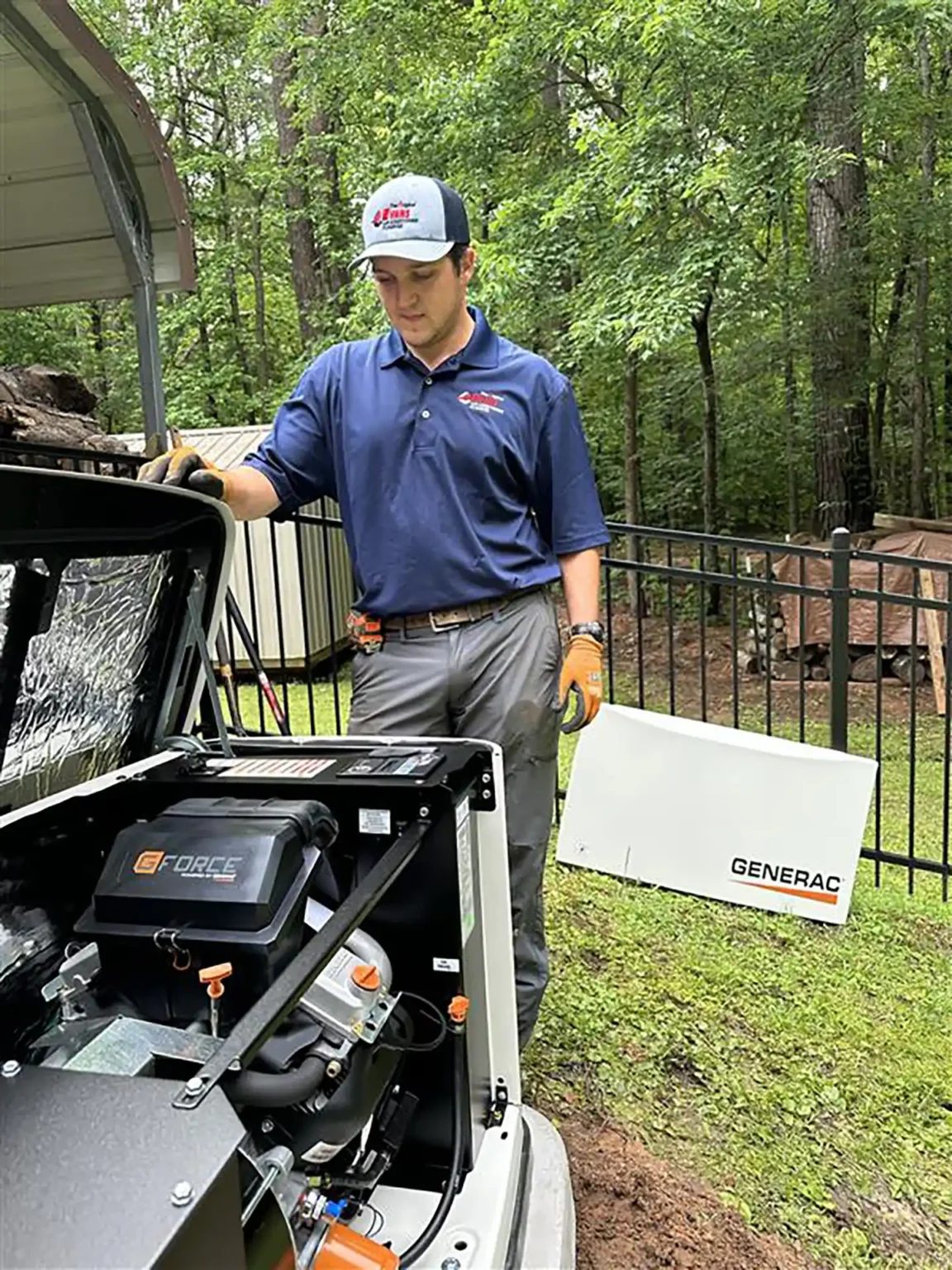Evans technician preparing a Generac G-Force standby generator unit for installation at a home