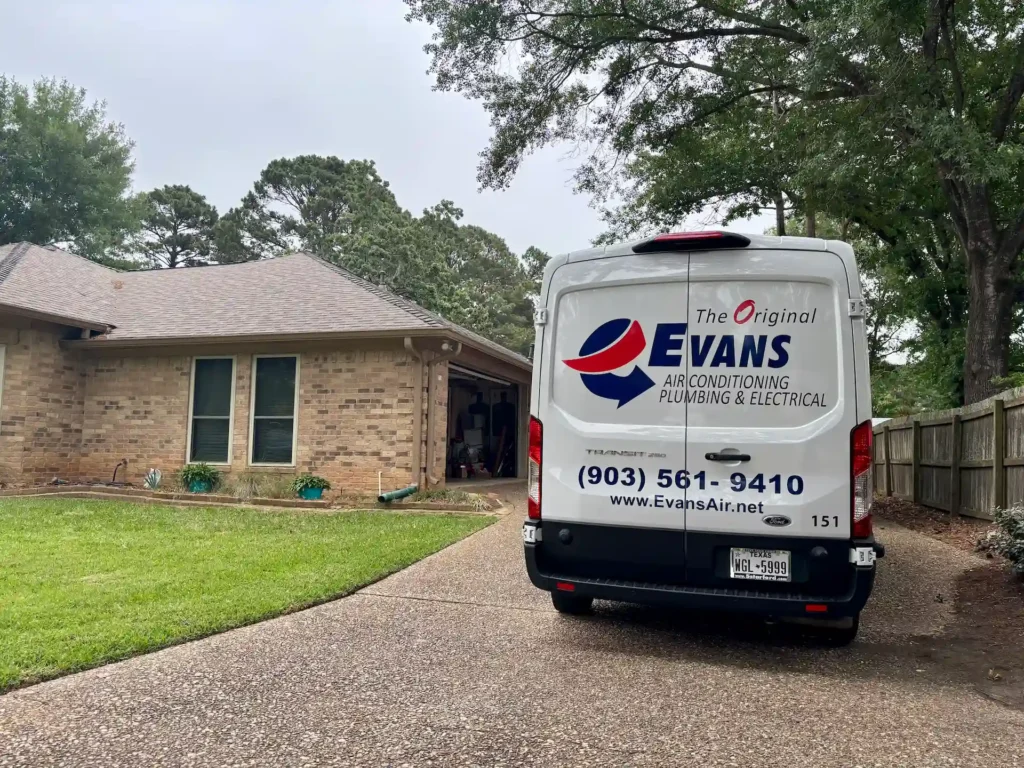 Evans Air Conditioning Plumbing and Electrical service van parked in a residential driveway