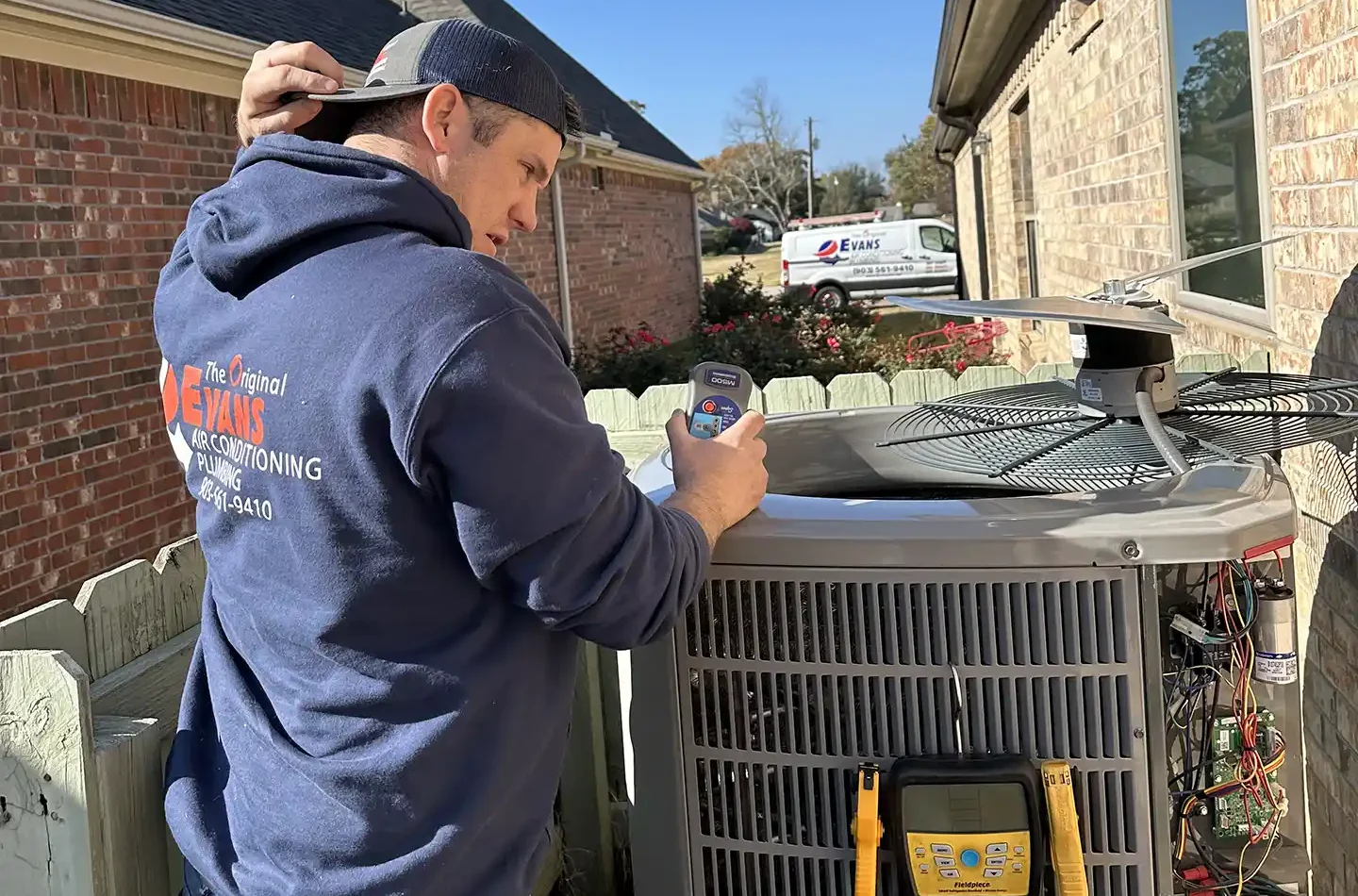 technician working on an ac repair in company uniform